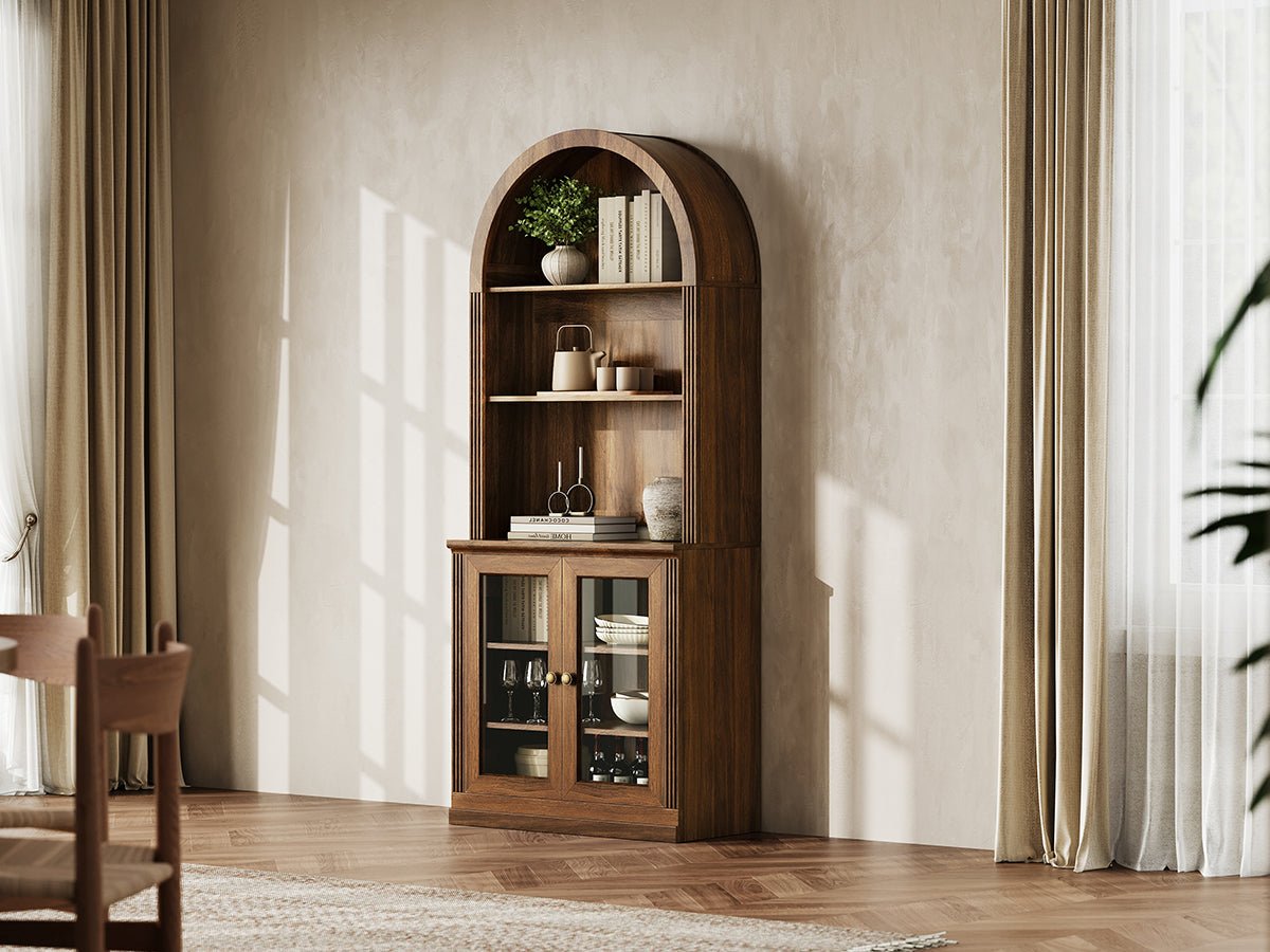 Monos walnut tall arch-top display cabinet styled in a warm lifestyle room scene