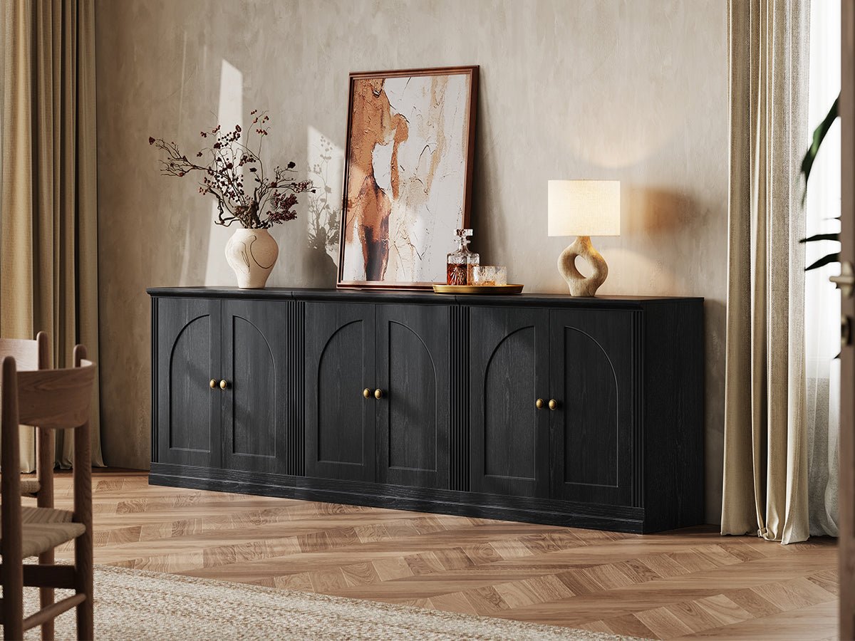 MONOS black modular sideboard cabinet set with three hinged storage cabinets styled under wall art in a modern living room