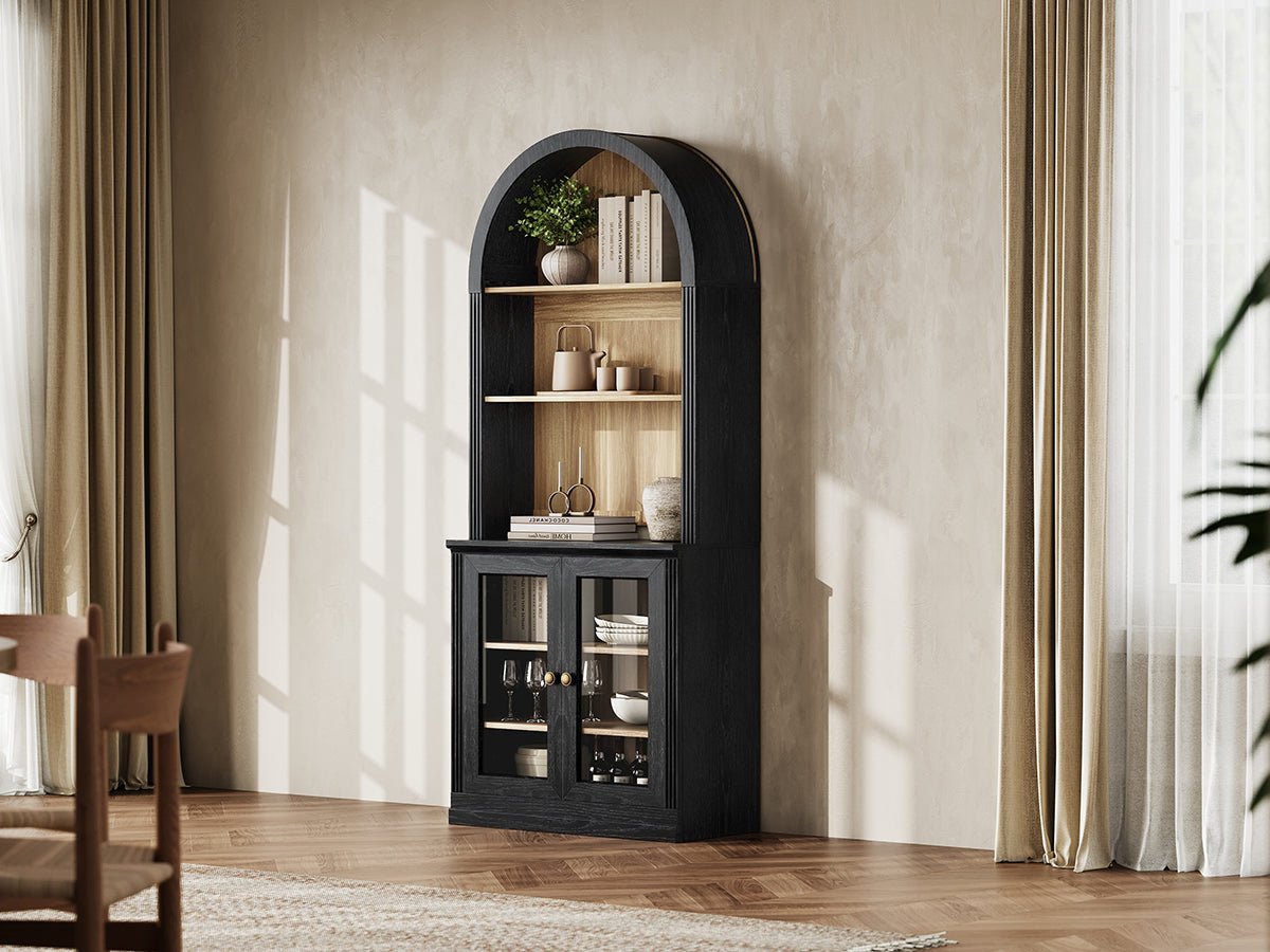Monos black tall arch-top display cabinet styled in a bright lifestyle room scene