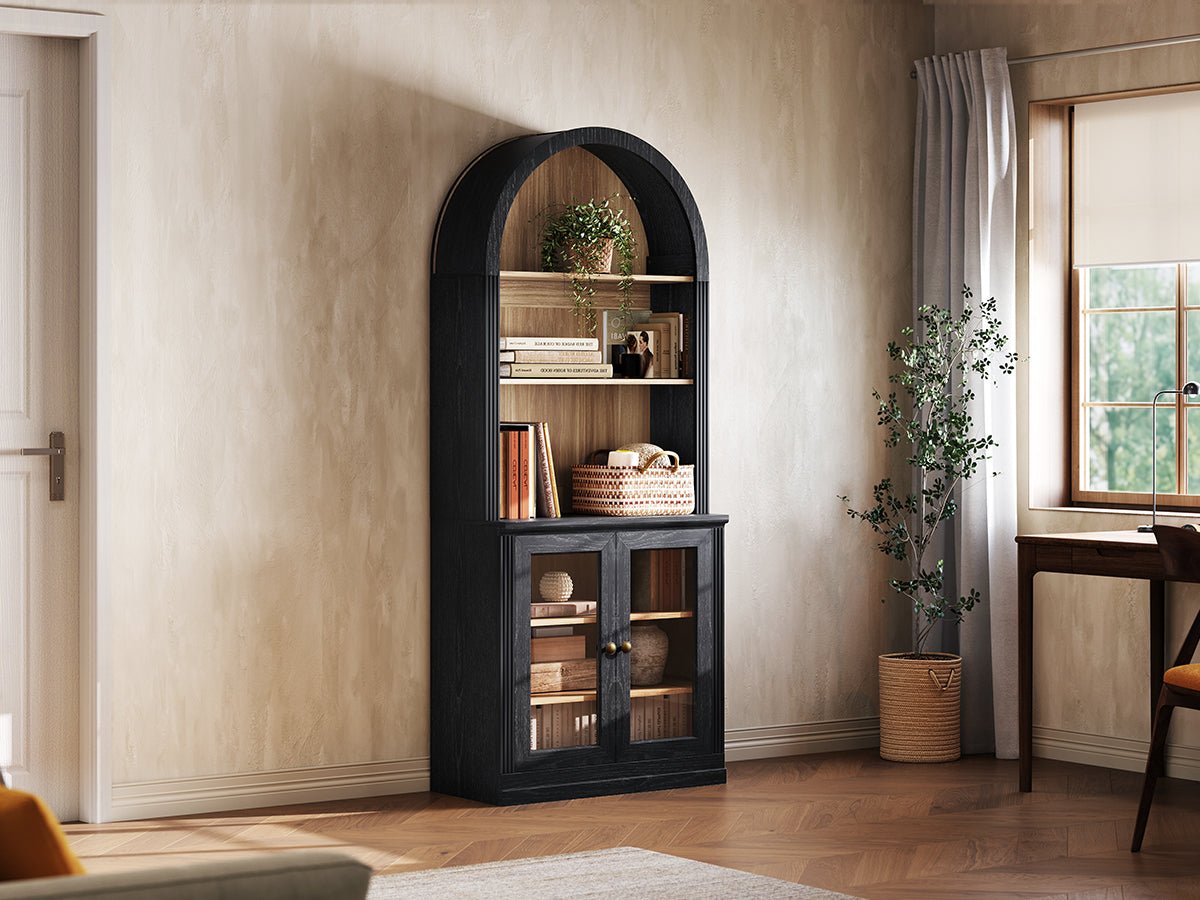Monos black tall display cabinet shown beside a window with books and decor inside