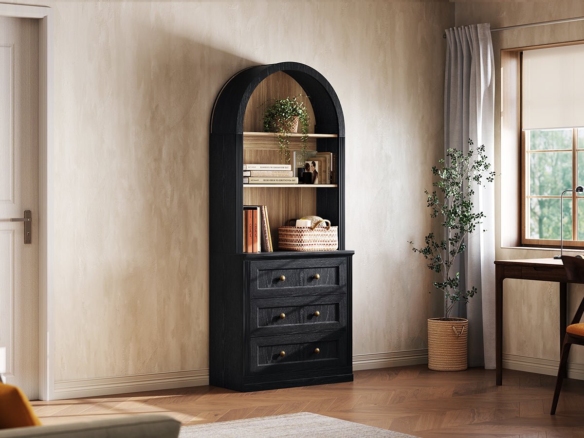 Monos black tall drawer cabinet shown beside a window with books and decor