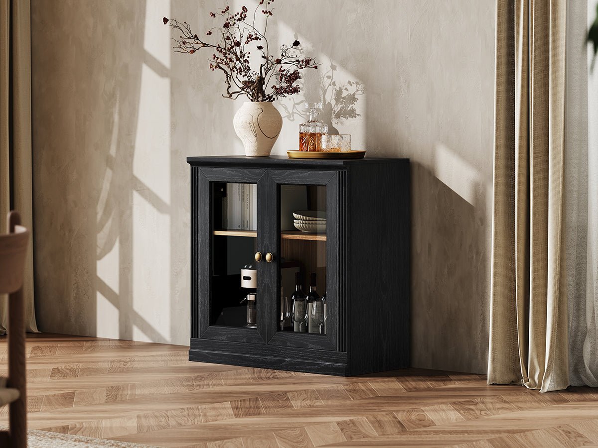Monos black glass door display cabinet styled in a lifestyle room scene with decor