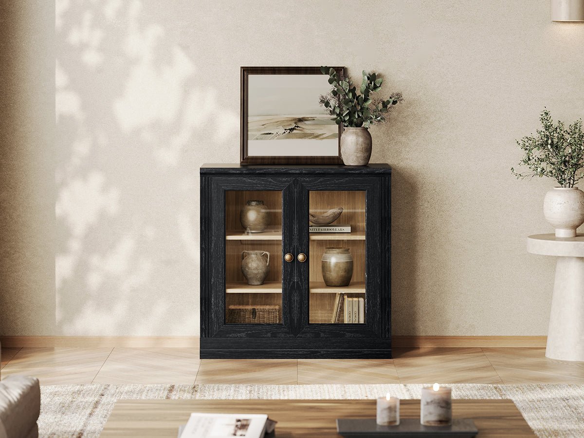 Monos black modular display cabinet with glass doors in a modern living room setting