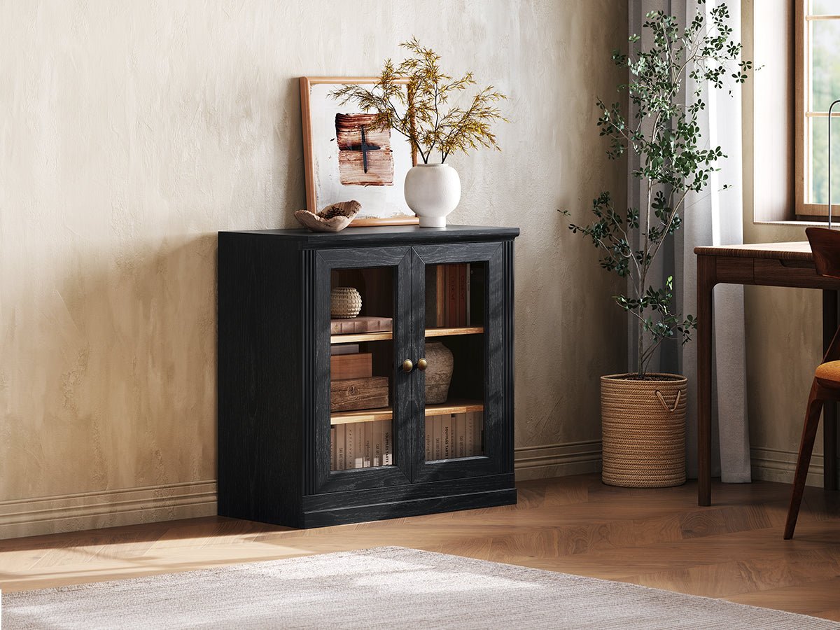 Monos black display storage cabinet shown beside a window with books and decor inside