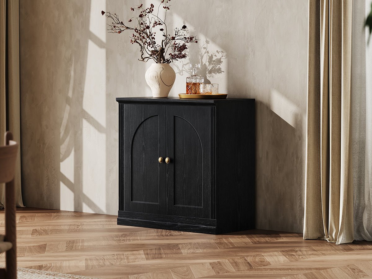 Monos black hinged storage cabinet styled in a lifestyle room scene with tabletop decor