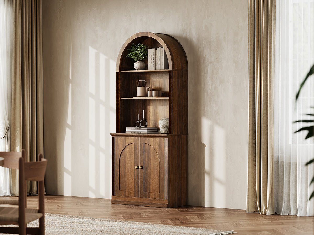Monos walnut tall arch-top hinged cabinet styled in a warm lifestyle room scene