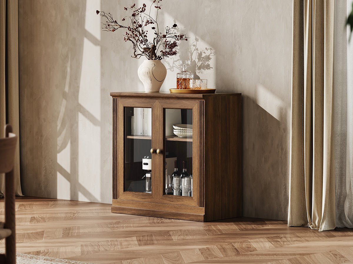Monos walnut glass door display cabinet styled in a lifestyle room scene with decor