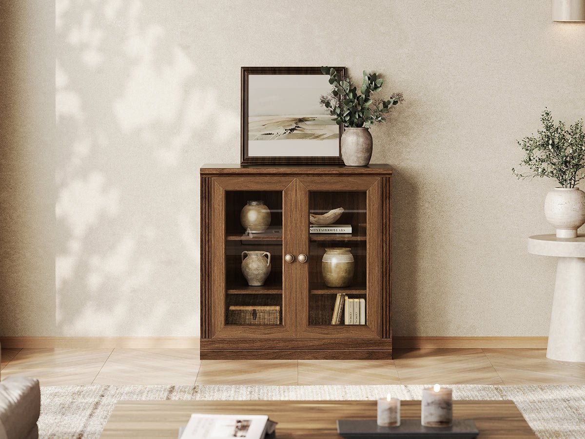 Monos walnut modular display cabinet with glass doors in a warm living room setting