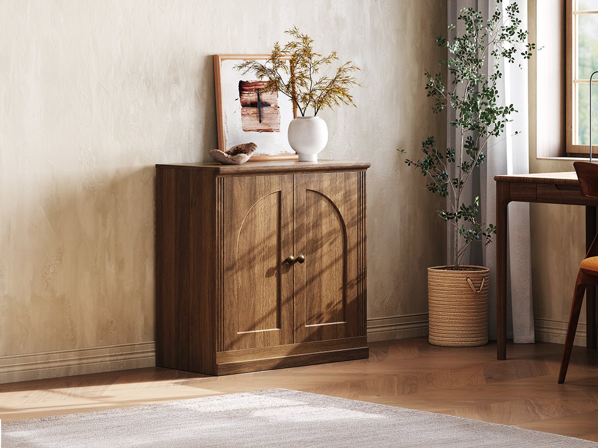 Monos walnut hinged storage cabinet displayed beside a window in a cozy room scene