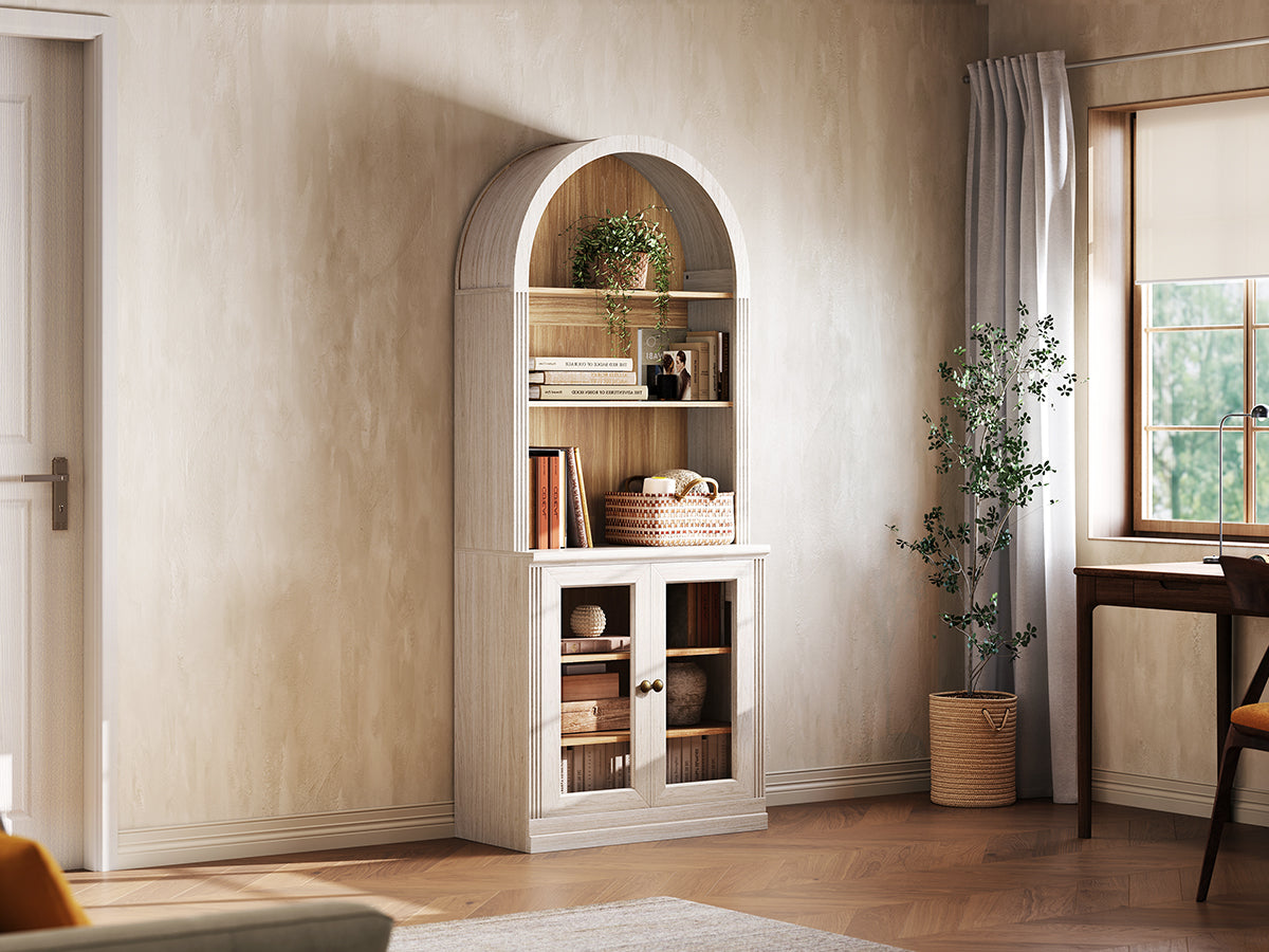 Monos white tall display cabinet shown beside a window with books and decor inside