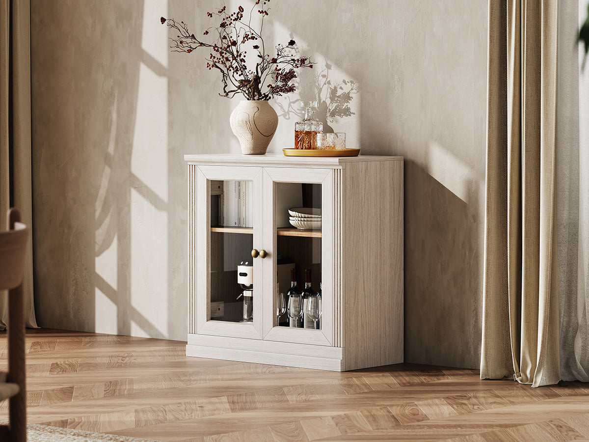 Monos white glass door display cabinet styled in a bright lifestyle room scene
