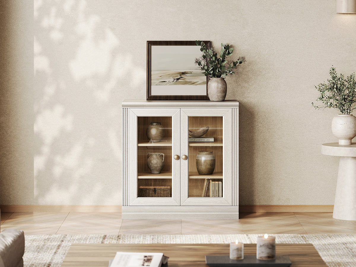 Monos white modular display cabinet with glass doors in a modern living room setting