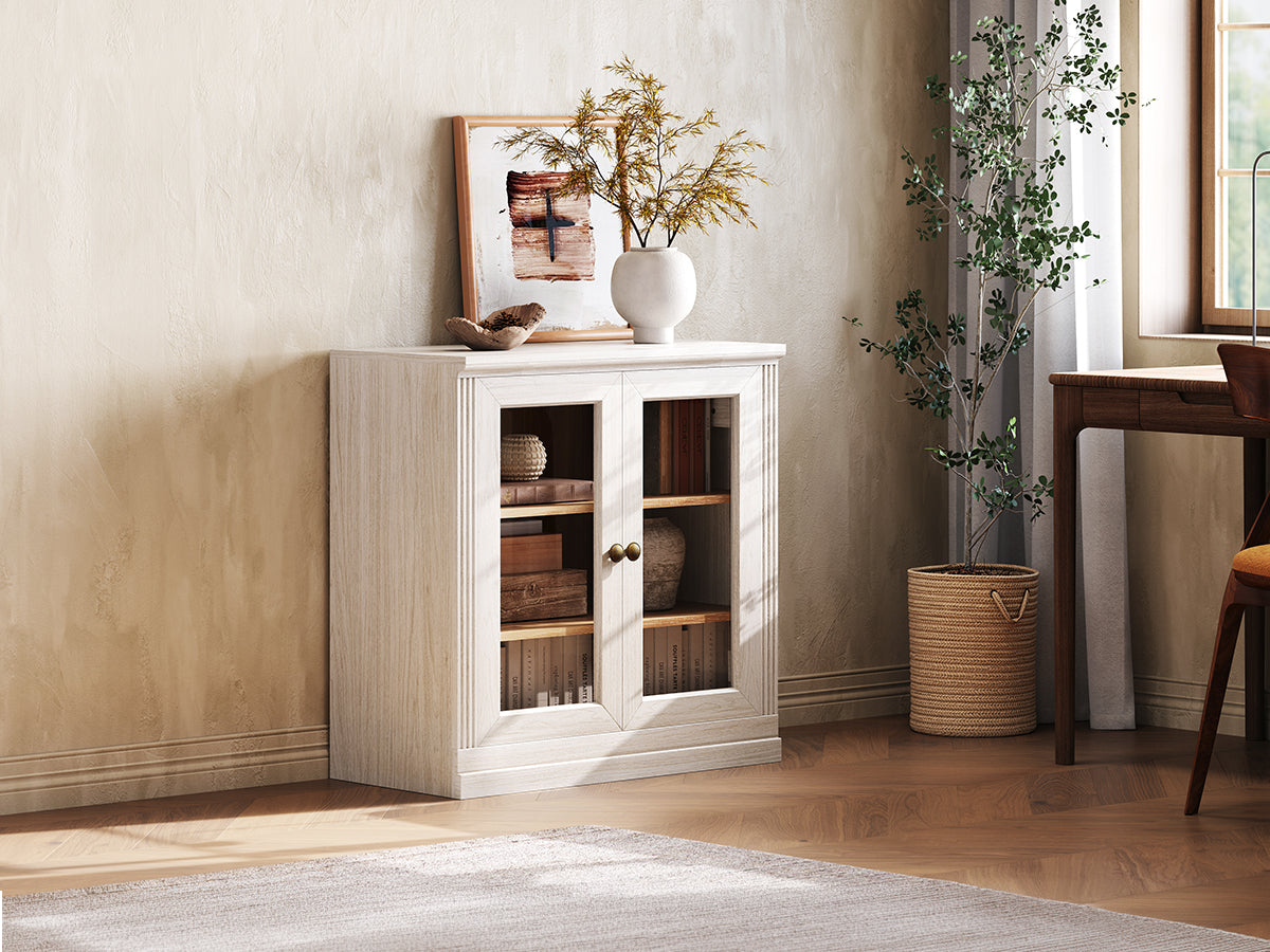 Monos white display storage cabinet shown beside a window with books and decor inside