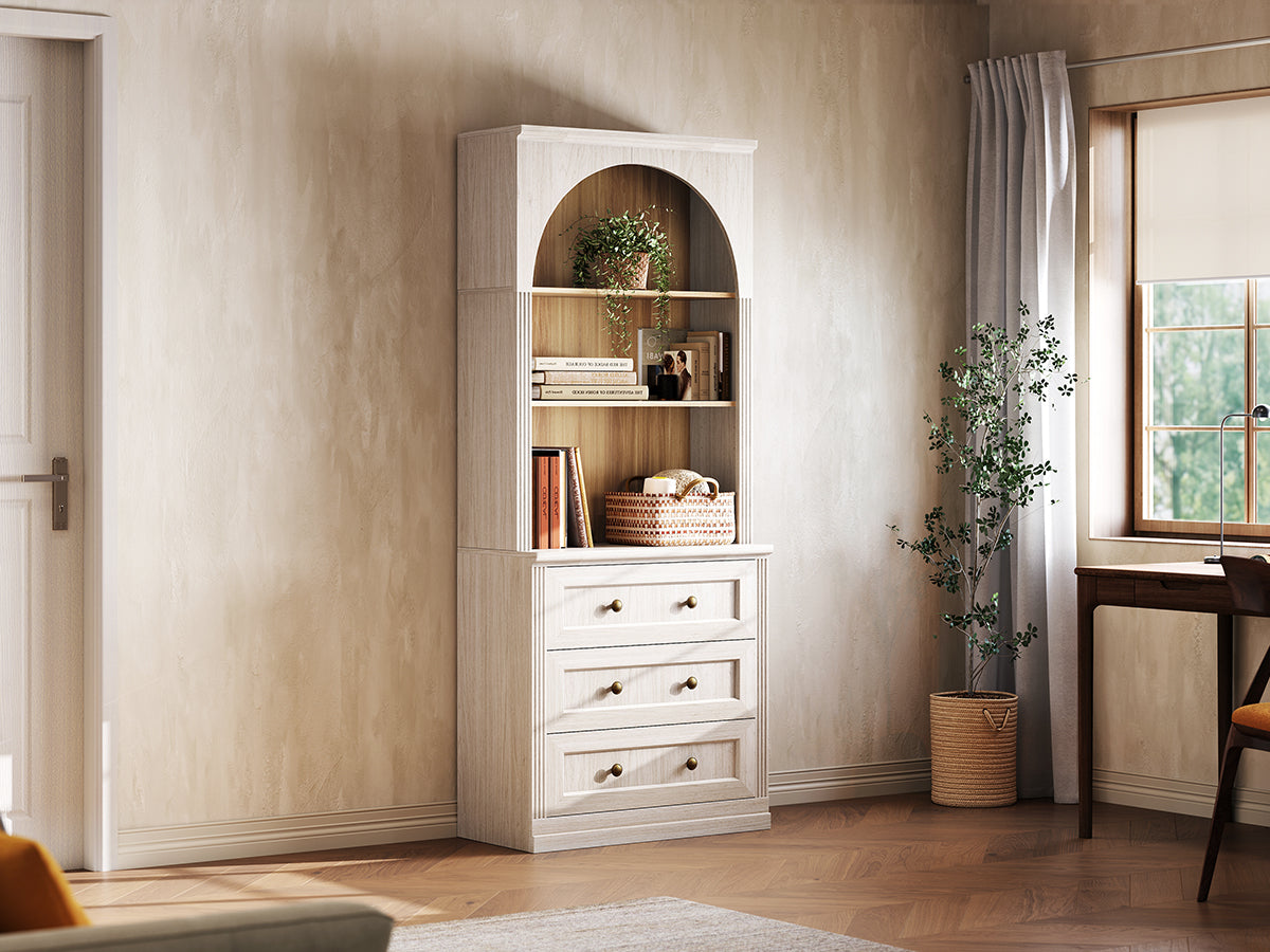 Monos white tall drawer cabinet displayed beside a window with books and decor
