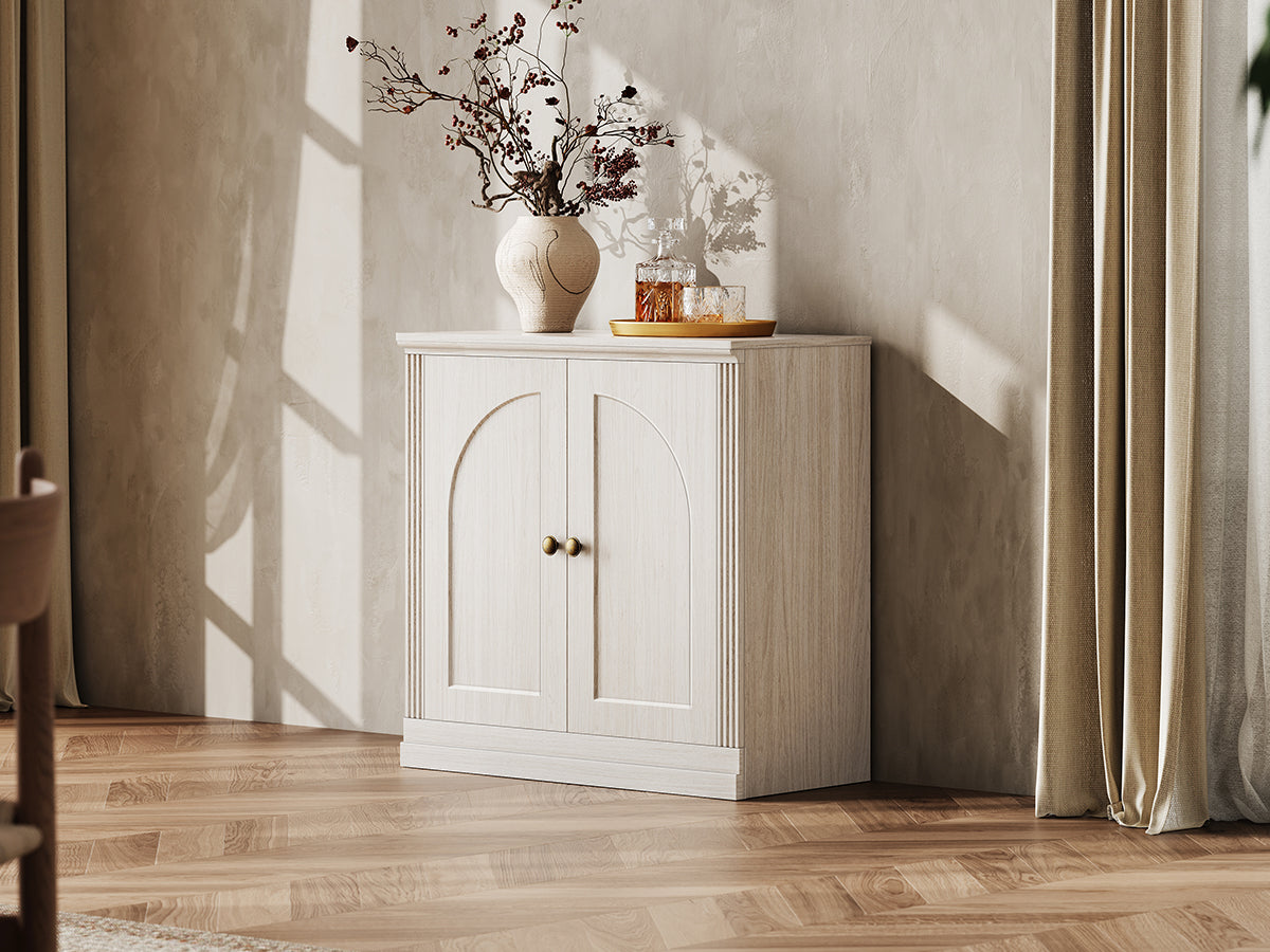 Monos white hinged storage cabinet styled in a lifestyle room scene with decor
