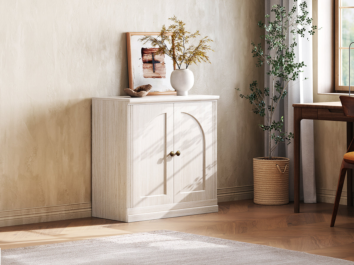 Monos white hinged storage cabinet displayed beside a window in a bright room scene