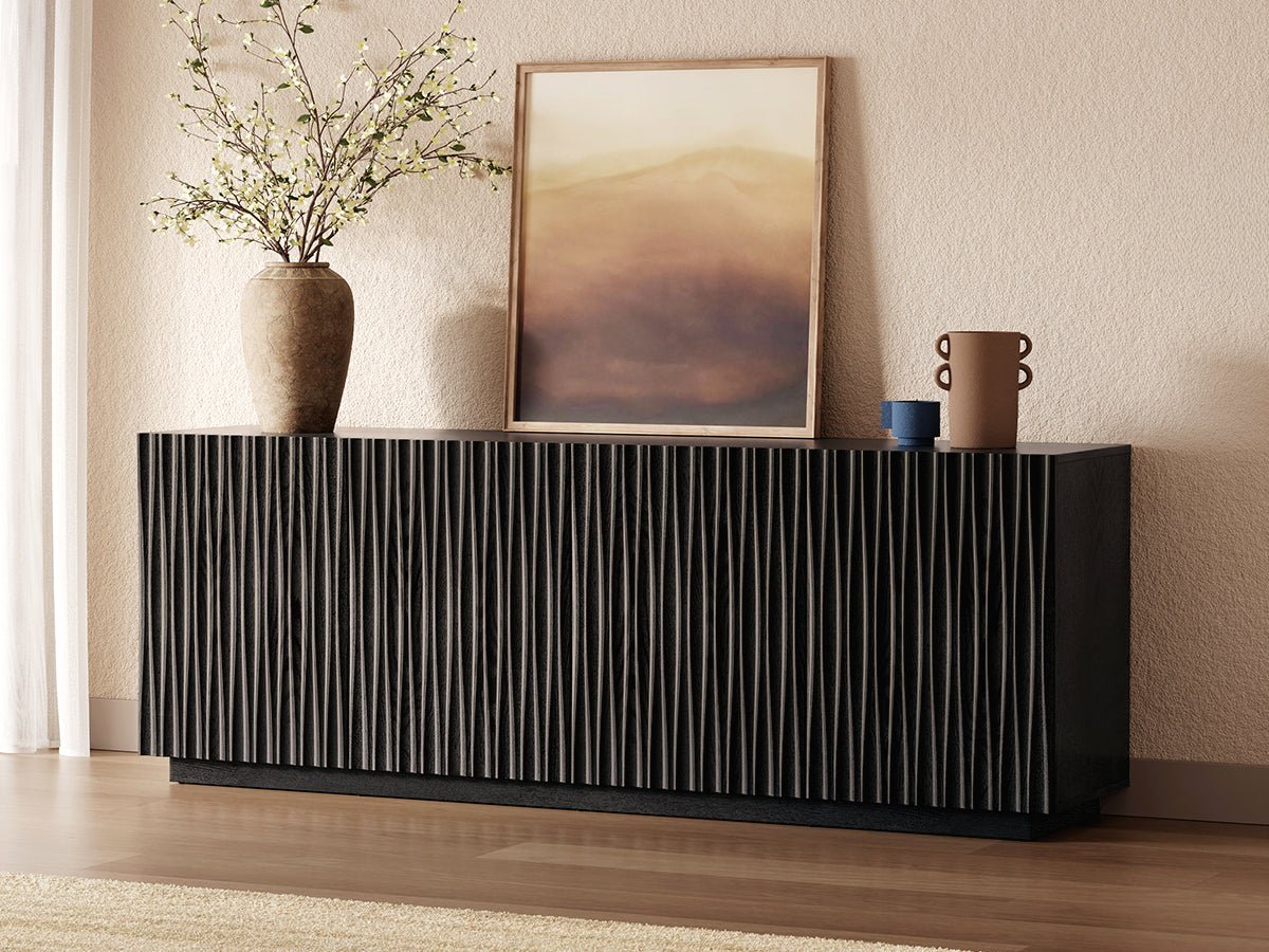 ORYVIA black wavy fluted storage cabinet used as a media console beneath a wall-mounted TV in a modern living room